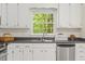 Kitchen with white cabinets, black countertops, and a stainless steel dishwasher at 1209 Shincliffe Ct, Cary, NC 27511