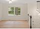 Bright living area featuring wood floors, stairs, and large windows letting in natural light at 1209 Shincliffe Ct, Cary, NC 27511