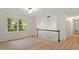 Bright living area featuring hardwood floors, stairs, and large windows letting in natural light at 1209 Shincliffe Ct, Cary, NC 27511