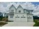 Beautiful home featuring white siding, a multi-car garage, and a well-manicured lawn under a cloudy sky at 1217 Azalea Garden Cir, Raleigh, NC 27603