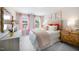 Bright bedroom featuring pink drapes, comfortable bed, side tables, and a decoratively framed mirror at 1268 Hardin Hill Ln, Knightdale, NC 27545