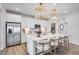 A modern kitchen features stainless steel appliances and a large island with barstool seating at 1268 Hardin Hill Ln, Knightdale, NC 27545