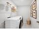 Functional laundry room featuring modern washer and dryer, storage shelves, and decoratively framed art at 1268 Hardin Hill Ln, Knightdale, NC 27545