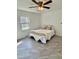Bedroom features unique wainscoting walls, a ceiling fan, and gray tiled floor, creating a cozy atmosphere at 131 Rosewood Dr Dr, Roxboro, NC 27573