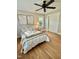 Bright bedroom featuring hardwood flooring, ceiling fan, a window and closet at 131 Rosewood Dr Dr, Roxboro, NC 27573