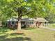 Charming one-story brick home with well-manicured lawn and a covered carport at 131 Rosewood Dr Dr, Roxboro, NC 27573