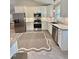 Modern kitchen featuring white cabinets, stainless steel appliances, granite countertops, and tile floors at 131 Rosewood Dr Dr, Roxboro, NC 27573
