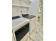 A convenient laundry room with modern, front loading appliances and built in shelves at 131 Rosewood Dr Dr, Roxboro, NC 27573