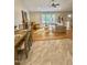 Inviting living room with a fireplace, light wood floors, and natural light streaming through large windows at 131 Rosewood Dr Dr, Roxboro, NC 27573