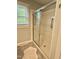 Modern bathroom featuring walk-in shower and window at 131 Rosewood Dr Dr, Roxboro, NC 27573
