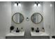 Modern bathroom featuring dual sinks, mirrors, and contemporary fixtures at 1336 Hill St, Rocky Mount, NC 27801