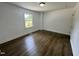 Well-lit bedroom with hardwood floors and a view of the outside through the window at 1336 Hill St, Rocky Mount, NC 27801