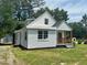 Charming home featuring a quaint covered porch and a well-maintained lawn at 1336 Hill St, Rocky Mount, NC 27801