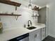 Functional kitchen featuring grey shaker cabinets and floating wood shelves at 1336 Hill St, Rocky Mount, NC 27801