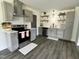 Modern kitchen with stainless steel appliances, gray cabinetry, and hardwood floors at 1336 Hill St, Rocky Mount, NC 27801