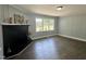 Inviting living room with a black fireplace, a large window, and hardwood flooring at 1336 Hill St, Rocky Mount, NC 27801