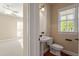 Well-lit powder room featuring pedestal sink and classic fixtures, with easy access to the bedroom at 134 Barclay Valley Dr, Cary, NC 27519
