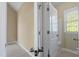 Neutral colored bathroom with a window and a doorway leading to another room at 134 Barclay Valley Dr, Cary, NC 27519