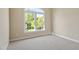 Light filled bedroom featuring a large window and neutral colored carpet at 134 Barclay Valley Dr, Cary, NC 27519