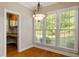 Sunny breakfast nook with hardwood floors, large windows, and a stylish chandelier with view to office area at 134 Barclay Valley Dr, Cary, NC 27519