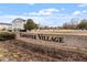 Welcoming community sign for Carpenter Village with lush landscaping and a beautifully designed neighborhood in the background at 134 Barclay Valley Dr, Cary, NC 27519