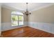 Elegant dining room with hardwood floors, chandelier, and wainscoting creating an inviting atmosphere at 134 Barclay Valley Dr, Cary, NC 27519
