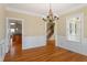Dining room with hardwood flooring, chandelier, and large windows, providing a bright and elegant space at 134 Barclay Valley Dr, Cary, NC 27519