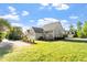 Beautiful home exterior with a spacious backyard, lush green lawn and gray siding at 134 Barclay Valley Dr, Cary, NC 27519