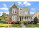 Inviting two-story home featuring a stone facade, covered porch, and beautifully landscaped front yard at 134 Barclay Valley Dr, Cary, NC 27519