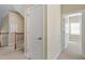 Upstairs hallway featuring a wooden banister and an open doorway to another room at 134 Barclay Valley Dr, Cary, NC 27519