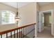 Upstairs hallway with natural light and an ornate light fixture hanging from the ceiling at 134 Barclay Valley Dr, Cary, NC 27519