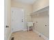 Practical laundry room with utility sink, tiled floor and access door, ready for easy chores at 134 Barclay Valley Dr, Cary, NC 27519