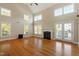 Bright living room features hardwood floors, fireplace and multiple windows for plenty of natural light at 134 Barclay Valley Dr, Cary, NC 27519