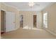 Sun-filled main bedroom with plush carpet, two entry doors, and large windows create a relaxing atmosphere at 134 Barclay Valley Dr, Cary, NC 27519