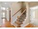 Inviting staircase with hardwood and carpet, seamlessly connecting floors with an elegant touch at 134 Barclay Valley Dr, Cary, NC 27519