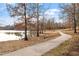 Scenic walking path alongside a serene lake, surrounded by trees and nature in this community at 134 Barclay Valley Dr, Cary, NC 27519