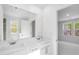 Bright bathroom showcasing a double vanity and access to another room with natural light at 1533 Crescent Townes Way, Raleigh, NC 27604