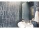 Stylish powder room featuring patterned blue wallpaper and a modern sink at 1533 Crescent Townes Way, Raleigh, NC 27604