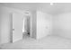A bright bedroom offers neutral walls, plush carpeting, and a hallway view at 1533 Crescent Townes Way, Raleigh, NC 27604