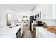 Bright, modern kitchen featuring white cabinets and an island with a sink at 1533 Crescent Townes Way, Raleigh, NC 27604