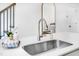 Kitchen island featuring a stainless steel sink, modern faucet and white countertop at 1533 Crescent Townes Way, Raleigh, NC 27604