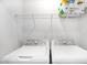 Well-equipped laundry room with modern washer, dryer, and convenient overhead shelving at 1533 Crescent Townes Way, Raleigh, NC 27604