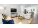 Spacious living room with hardwood floors, stylish seating, and adjacent kitchen at 1533 Crescent Townes Way, Raleigh, NC 27604