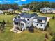 Aerial view of backyard featuring patio, mature trees and play area of this luxury home at 1633 Estate Valley Ln, Raleigh, NC 27613