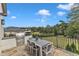 Backyard patio with grill, dining area, and beautifully landscaped greenery at 1633 Estate Valley Ln, Raleigh, NC 27613