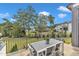 Enjoy outdoor dining on this backyard patio with a table, chairs, and lush landscaping at 1633 Estate Valley Ln, Raleigh, NC 27613