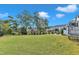Lush backyard featuring green lawn, trees, and other homes in the community at 1633 Estate Valley Ln, Raleigh, NC 27613