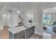 Modern bar with wine fridge, sink, and ample counter space for entertaining at 1633 Estate Valley Ln, Raleigh, NC 27613
