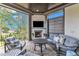 Inviting covered patio with fireplace, outdoor seating, and view of the backyard at 1633 Estate Valley Ln, Raleigh, NC 27613