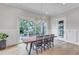 A dining room offers a wood table, seating for six, and light hardwood floors with access to the outdoor patio at 1633 Estate Valley Ln, Raleigh, NC 27613